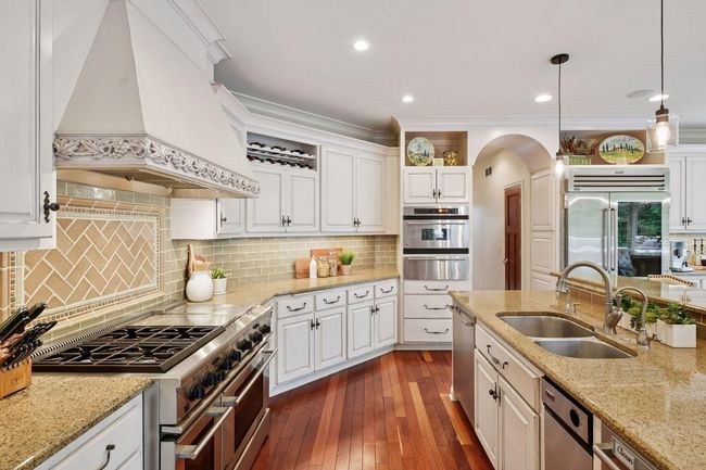Arched way to 1/2 bath and entry | Image 23