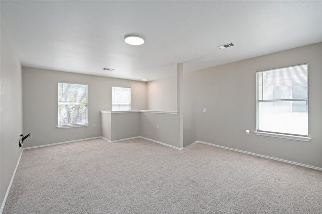 Carpeted empty room with visible vents and baseboards | Image 22