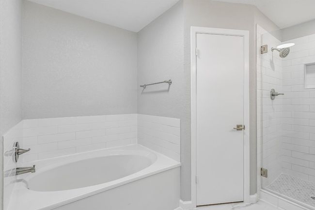 Full bathroom featuring a shower stall, baseboards, and a garden tub | Image 12