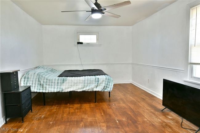 Bedroom featuring baseboards, ceiling fan, and wood-type flooring | Image 37