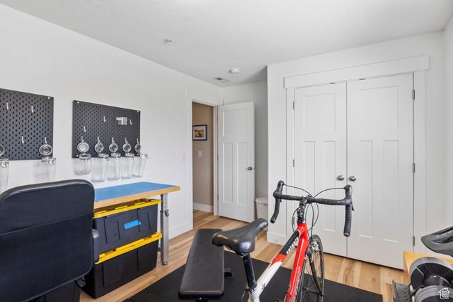 Workout area featuring baseboards and wood finished floors | Image 25