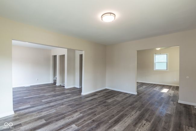 spare room featuring baseboards and dark wood-style floors | Image 18