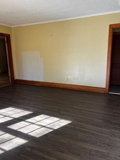 Empty room with ornamental molding and dark hardwood / wood-style floors | Image 3