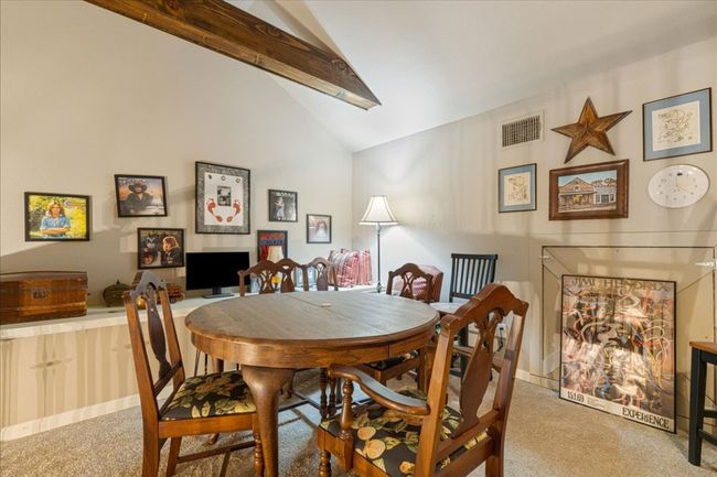 Dining room featuring visible vents, high vaulted ceiling, beam ceiling, and carpet floors | Image 34