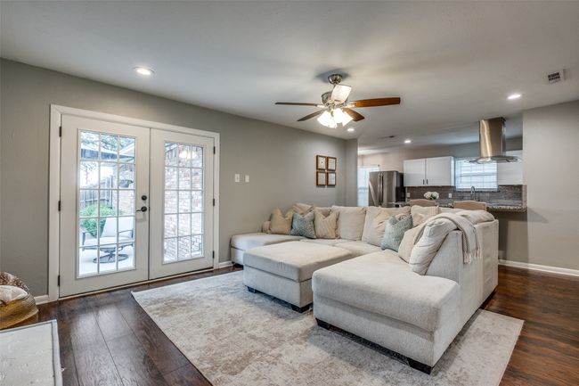 Living area featuring french doors, dark wood finished floors, ceiling fan, and recessed lighting | Image 17