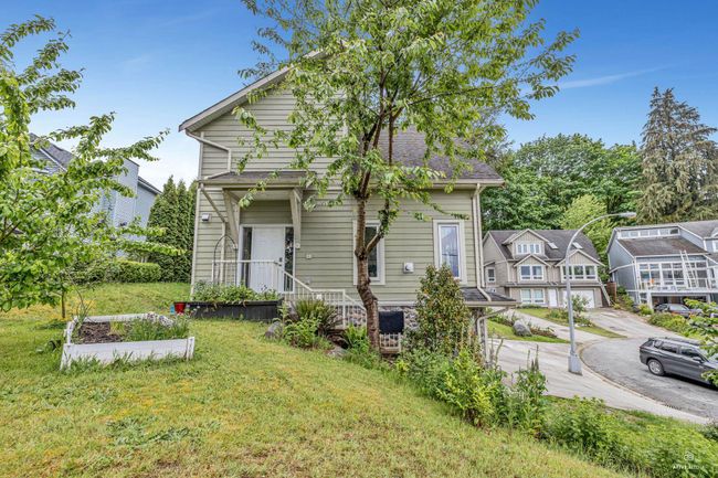View of front facade featuring a front yard, driveway, and a garage | Image 6