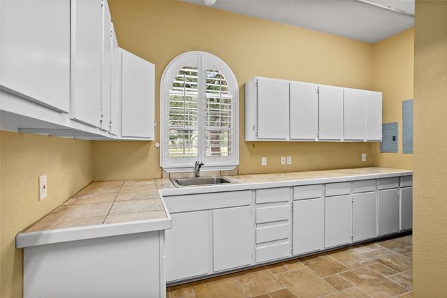 Oversized laundry room on main floor just off the kitchen with tons of storage | Image 22