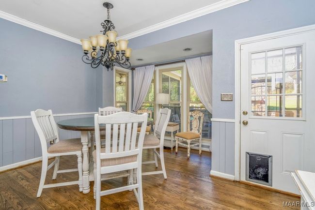 Breakfast room looks out to the screened back porch, the pool and the outdoor fireplace. | Image 23