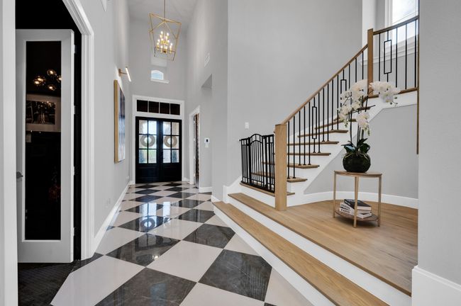Foyer entrance featuring a high ceiling, a chandelier, and stairs | Image 4