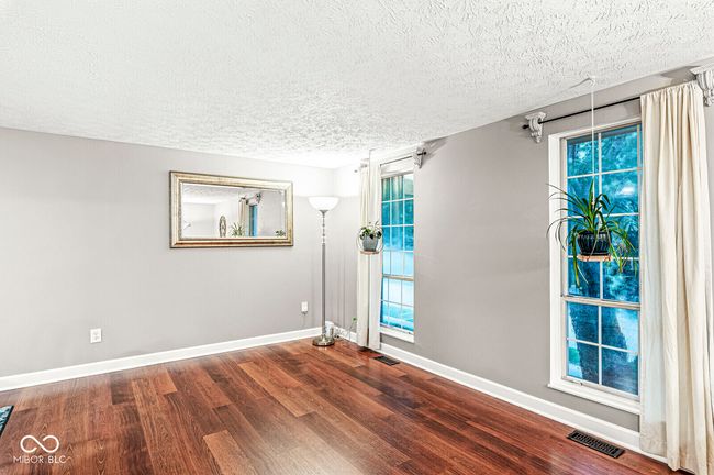 empty room featuring wood finished floors and a textured ceiling | Image 10