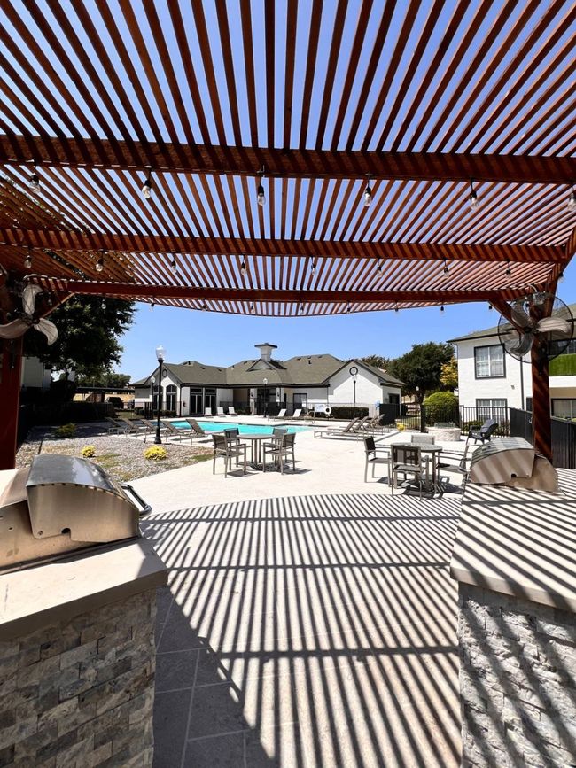 View of patio / terrace featuring a pergola, an outdoor kitchen, grilling area, and a swimming pool | Image 8