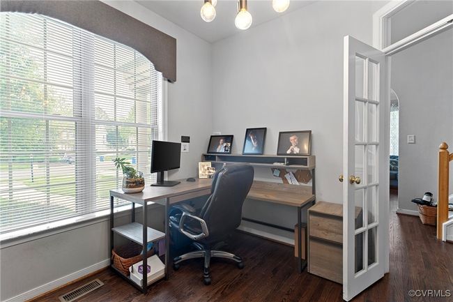 Home office featuring visible vents, a baseboard radiator, wood finished floors, and plenty of natural light | Image 26