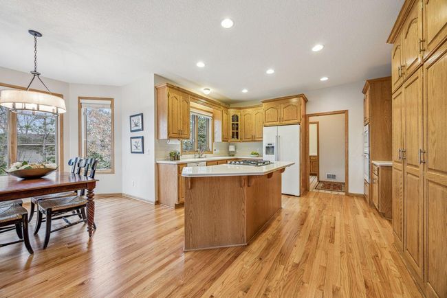 Nice recessed lighting and refinished wood floors. | Image 12