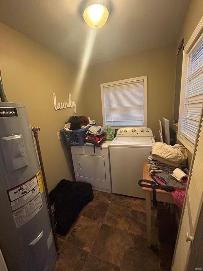 Laundry room with laundry area, independent washer and dryer, and electric water heater | Image 6