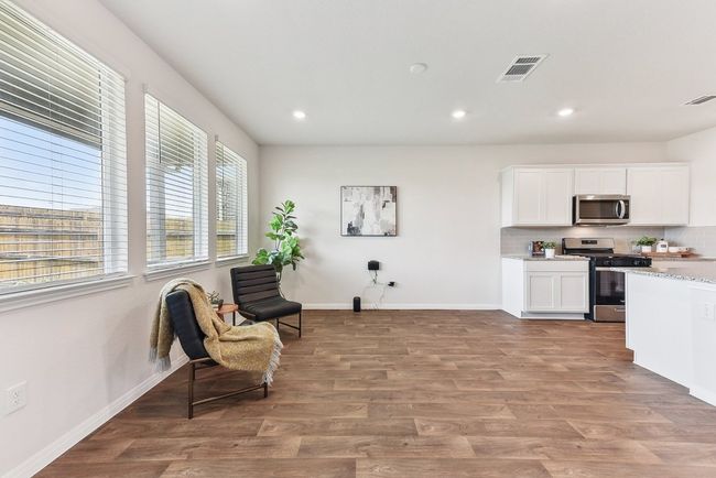 Heart of the Home: A spacious kitchen with granite countertops, sleek cabinetry, and a stylish backsplash. | Image 7
