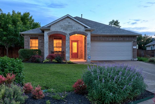 The exterior of the home is beautiful with gorgeous landscaping. The current owners installed rain gutters and covers. | Image 26