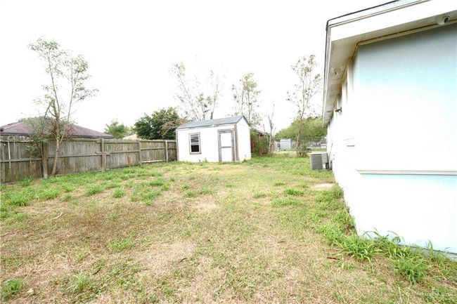 Fenced backyard with a storage shed | Image 16