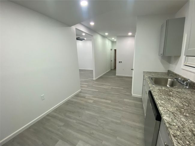 Kitchen with a sink, baseboards, gray cabinetry, light wood finished floors, and recessed lighting | Image 5