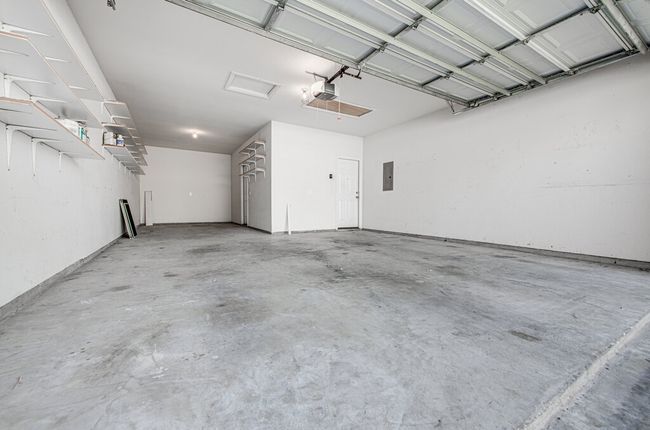 Garage with electric panel and a garage door opener | Image 18
