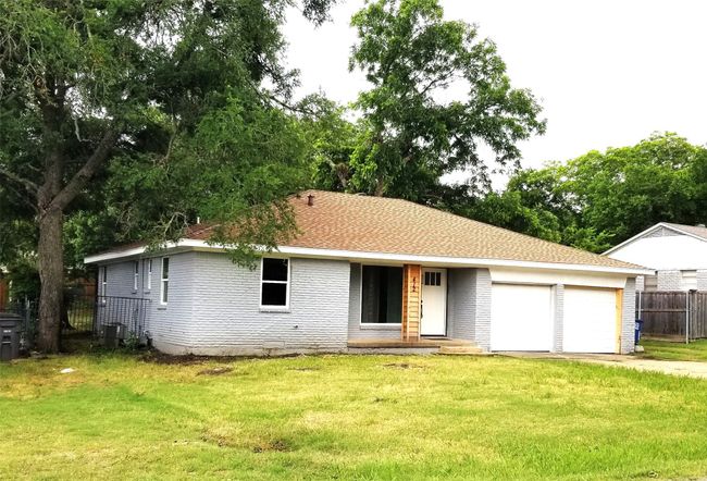 View of front of house featuring an attached garage, driveway, and brick siding | Image 38