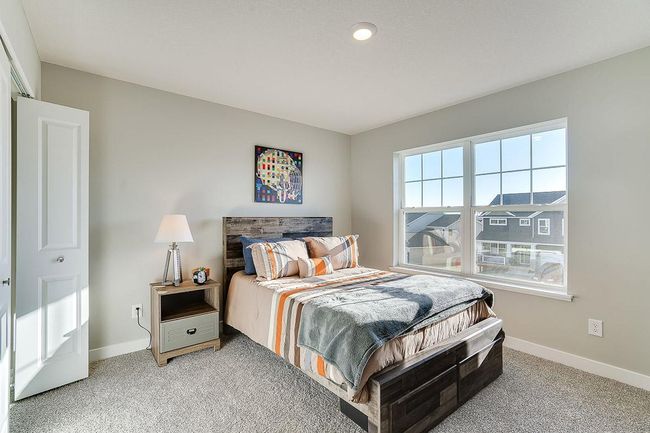 Space is also abundant in each of the home's three secondary bedrooms, all three of which are just steps from the upper-level loft! Photo of model home, color and options will vary. | Image 18