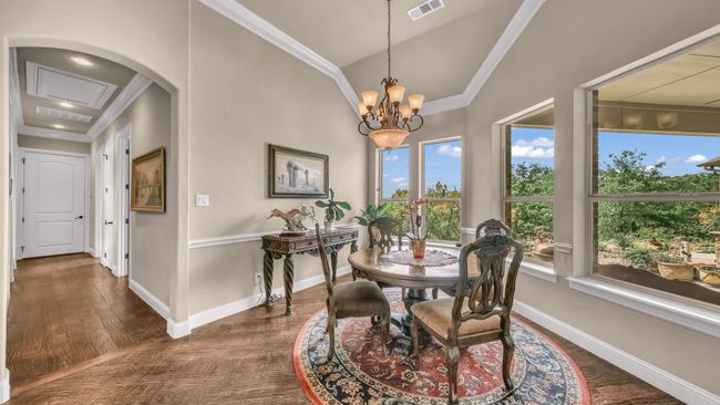 Dining area featuring crown molding, dark wood-style flooring, baseboards, and visible vents | Image 19