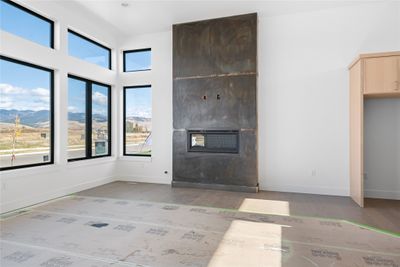 Unfurnished living room featuring a mountain view and hardwood / wood-style flooring | Image 2