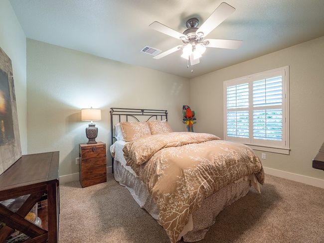 Carpeted bedroom with a ceiling fan and baseboards | Image 18