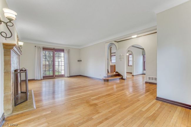 Gleaming wood floors and French doors welcome you to the expansive outdoor stone patio | Image 8