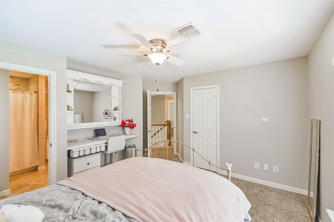 Charming bedroom with a built-in vanity, perfect for personal pampering. | Image 33