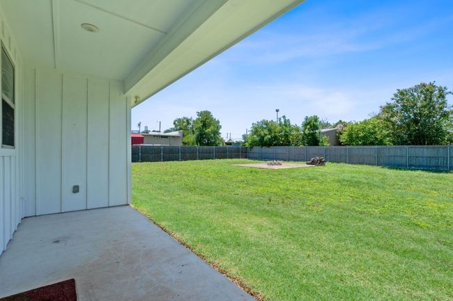 Fenced backyard with a patio area and an outdoor fire pit | Image 31