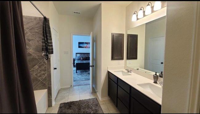 Ensuite bathroom featuring double vanity and tile patterned floors | Image 22