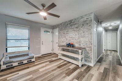 Entrance foyer featuring ceiling fan and light wood-type flooring | Image 3