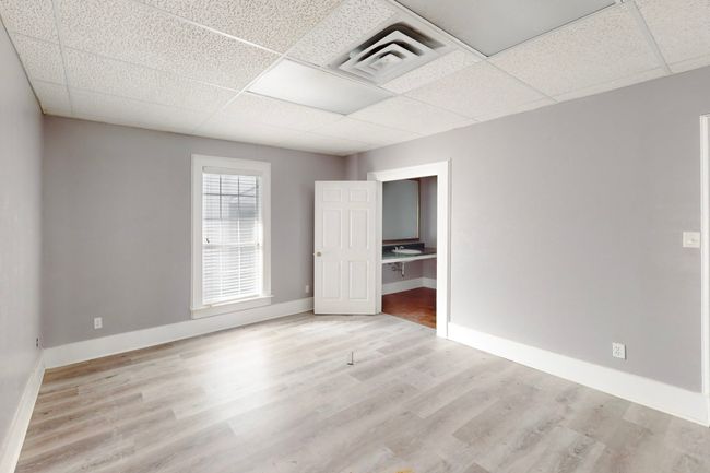 Unfurnished room with a drop ceiling and light hardwood / wood-style floors | Image 18