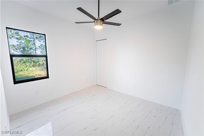 Spare room with ceiling fan | Image 19