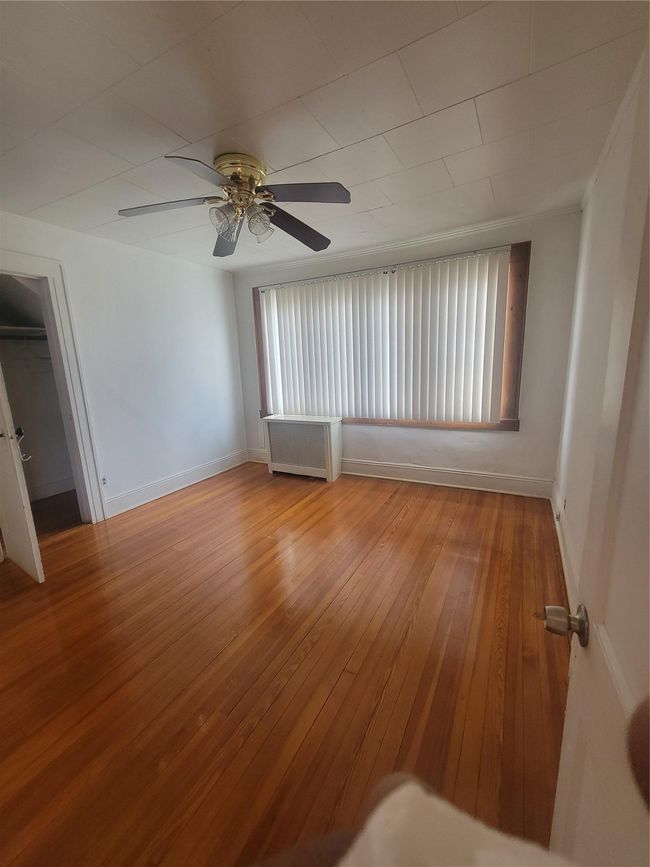 Empty room featuring a ceiling fan, hardwood / wood-style flooring, and baseboards | Image 10
