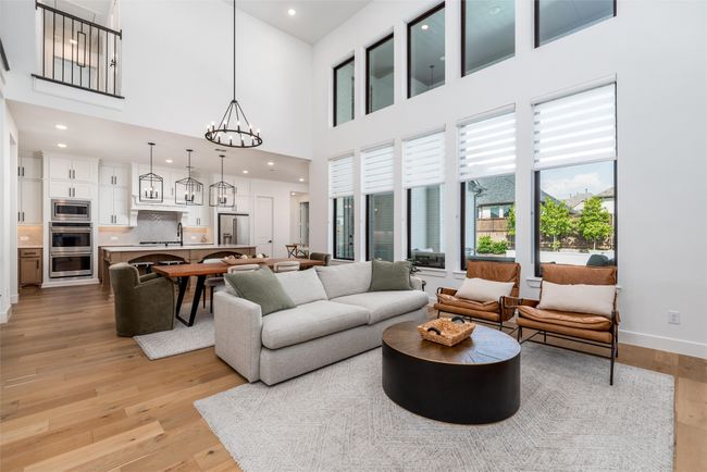 Stunning Family Room open to kitchen and with wall of windows looking onto pool in backyard | Image 10