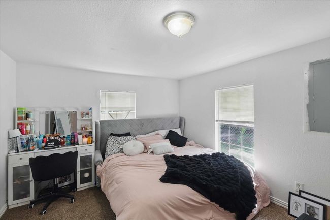Carpeted bedroom with electric panel | Image 10