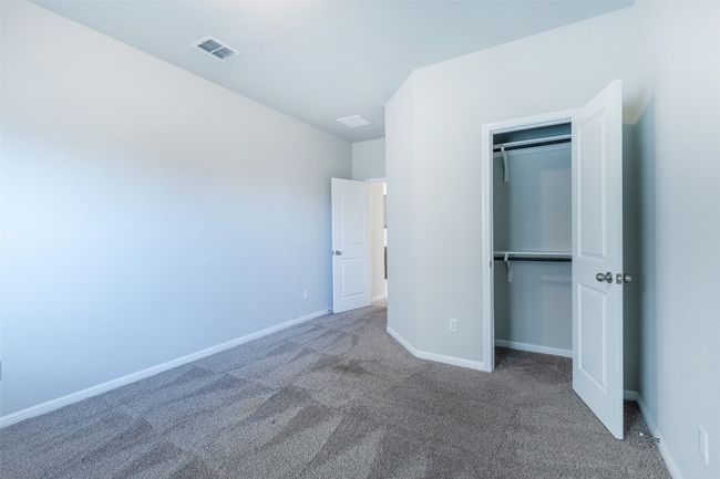 Unfurnished bedroom with a closet, visible vents, baseboards, and carpet floors | Image 19