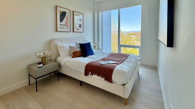 Bedroom with light wood finished floors and baseboards | Image 13