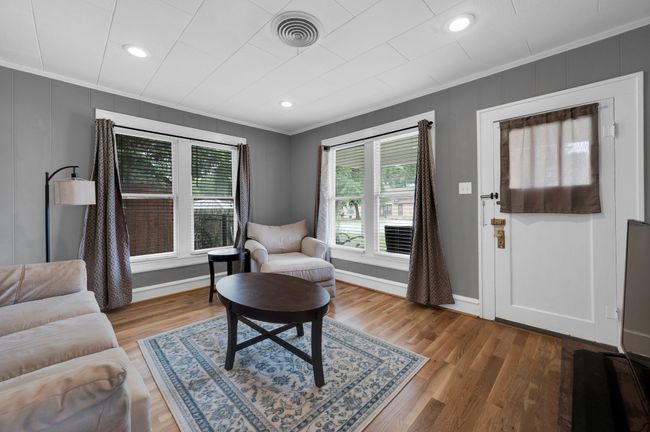 Living room with crown molding, wood finished floors, baseboards, and recessed lighting | Image 5