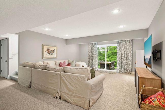 The walk-out lower level features a spacious family room.. | Image 35
