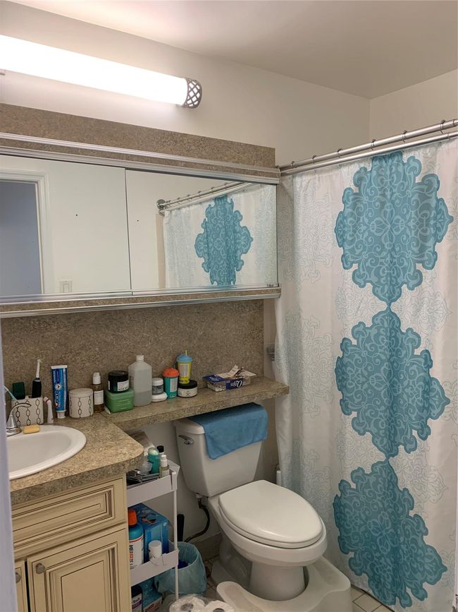 Bathroom featuring backsplash, vanity, toilet, and a shower with curtain | Image 8