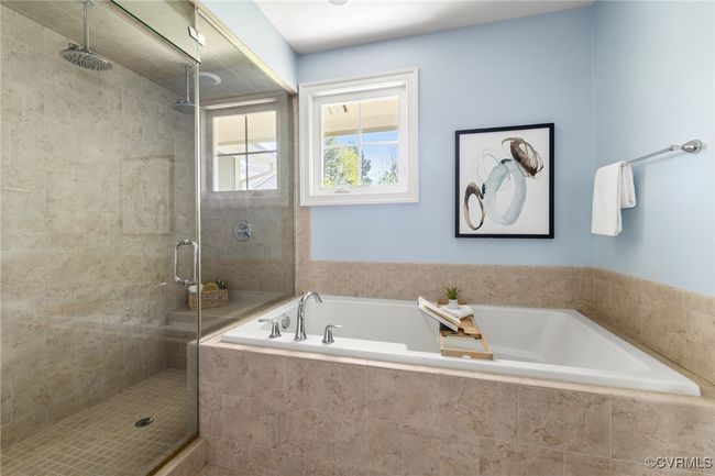 Tile floor, oversized soaking tub, raised double vanity with grantie counters, water closet, tile surround steam shower with tile pan | Image 26