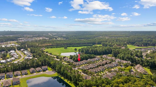 Aerial perspective of suburban area featuring a nearby body of water and a local golf course | Image 39