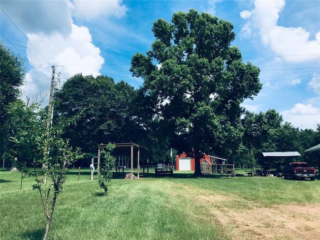 In the foreground, please notice the covered area that is fully wired, for a Large Motor Home. In the background, you will notice the Large Red Barn, which also will house a motor home, and all of your toys. | Image 34