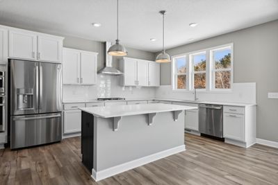 (Photo of a decorated model, actual homes finishes will vary) Entertain in this beautiful gourmet kitchen. | Image 2