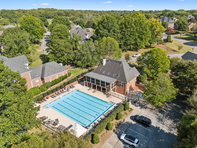 The community clubhouse can be rented to host parties and has a full kitchen. The pool area has a kiddie pool and large pool. There is a walking trail that goes down to the lake and community boat docks. | Image 49