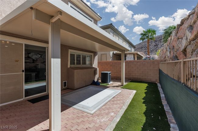 View of patio with a fenced backyard and cooling unit | Image 28