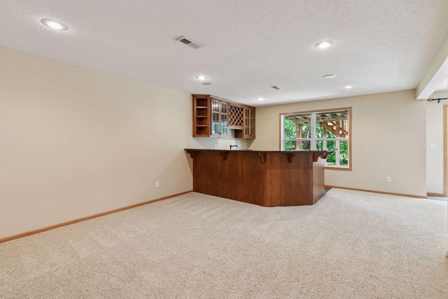 The walkout lower has a large amusement room and a fabulous wet bar with a granite rail | Image 21